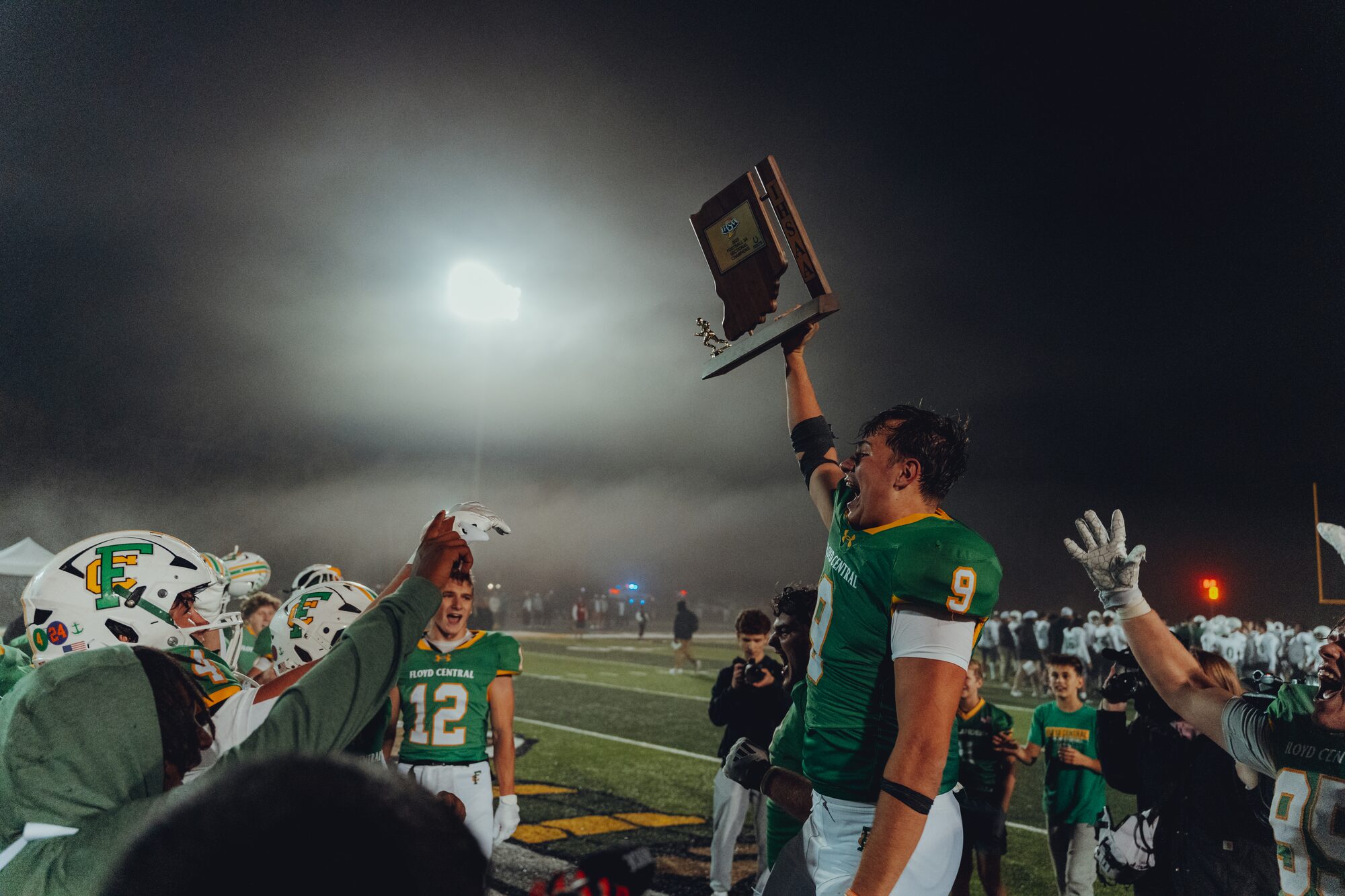 Floyd Central football players celebrating a sectional title in the fog